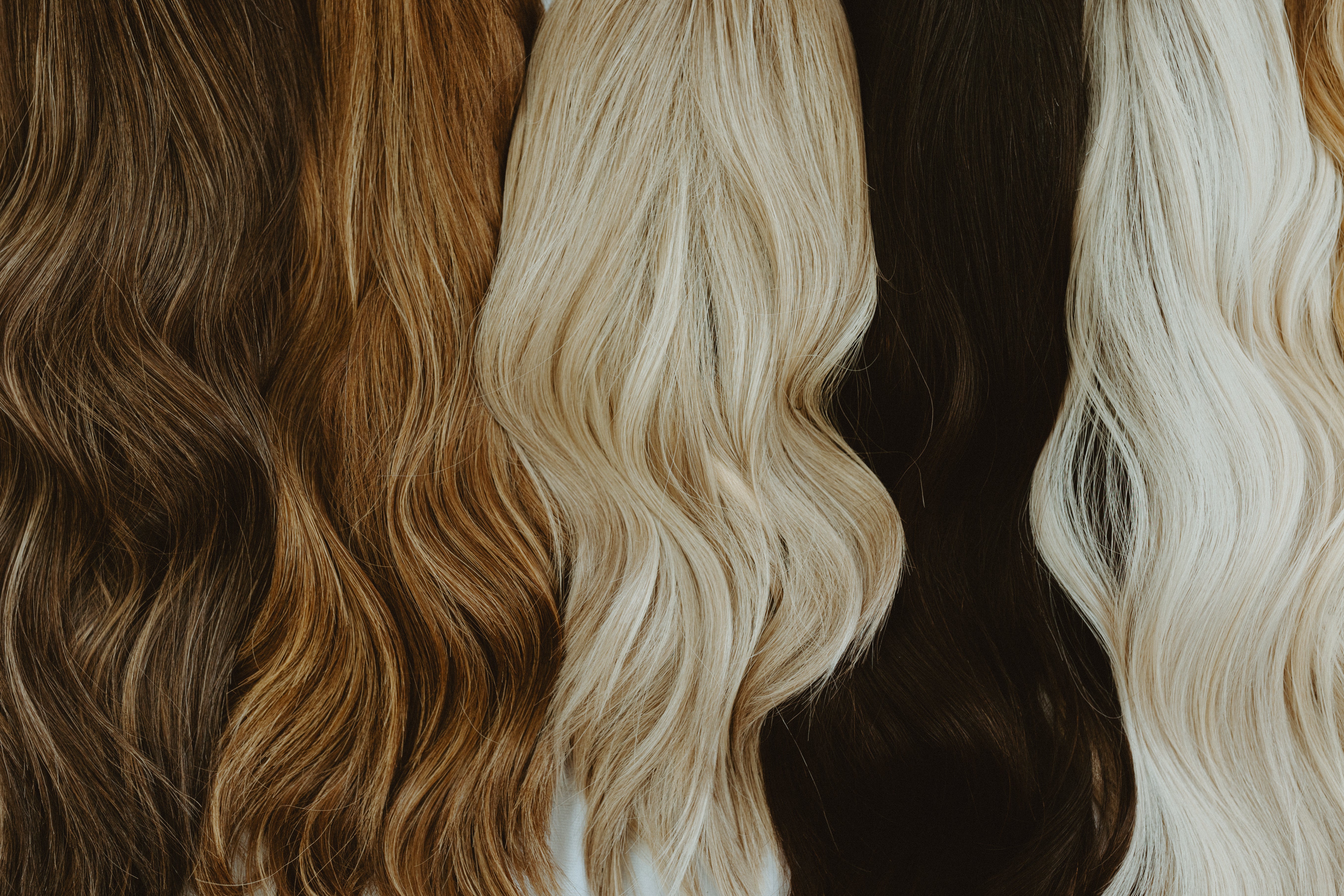 varierty of wigs, and colors that we can custom color laying beside each other